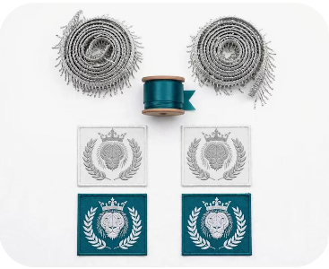 Royal Judah Embellishment Kit — 4 silver embroidered lion crest patches on white and teal twill, silver bugle bead fringe spools, and teal liquid satin ribbon spool
