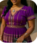 Chayil Heritage Boho Midi Dress in Royal Purple — front view showing gold embroidery on neckline, cuffs, and tiered hem with gold bangle accessories